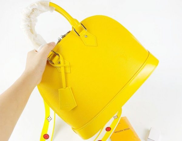 Replica Louis Vuitton Epi Leather Alma PM Handbag In Cedrat Yellow With Jacquard Strap - Image 2