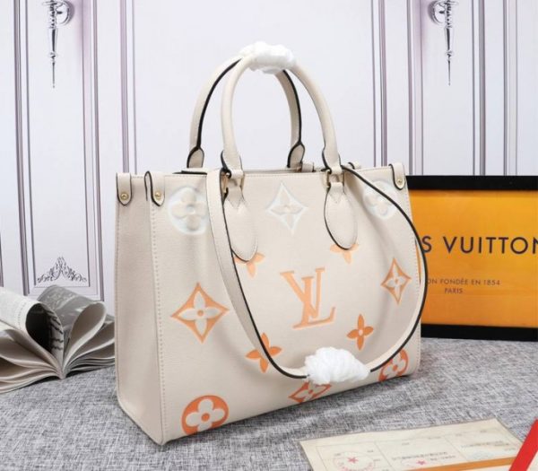 Replica Louis Vuitton Monogram Empreinte Leather Onthego MM Bag In Cream Saffron - Image 2